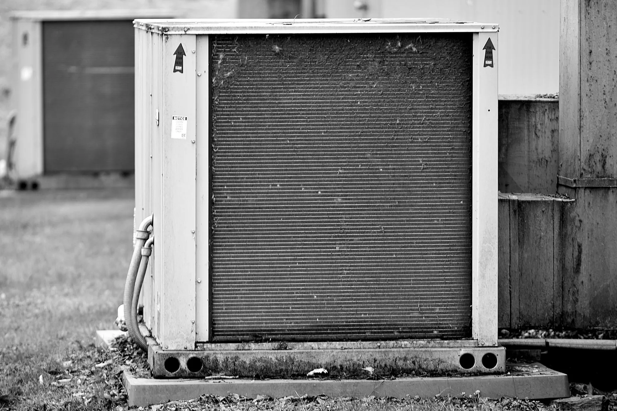 Close-up of a commercial HVAC condenser unit showing coils and metal casing